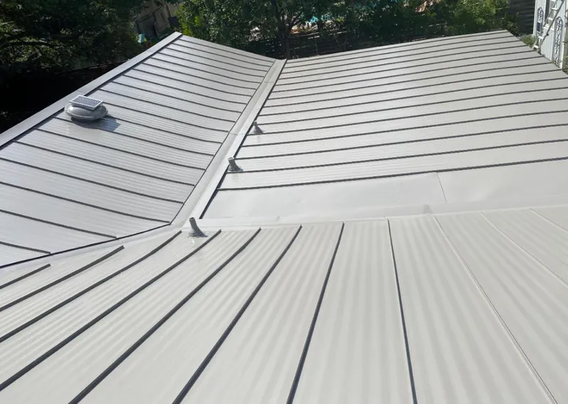 Solar attic fan installed on a metal roof for Roof Ventilation in Lakeland North